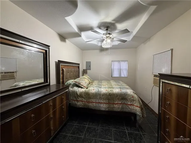 a bedroom with a bed and a tv