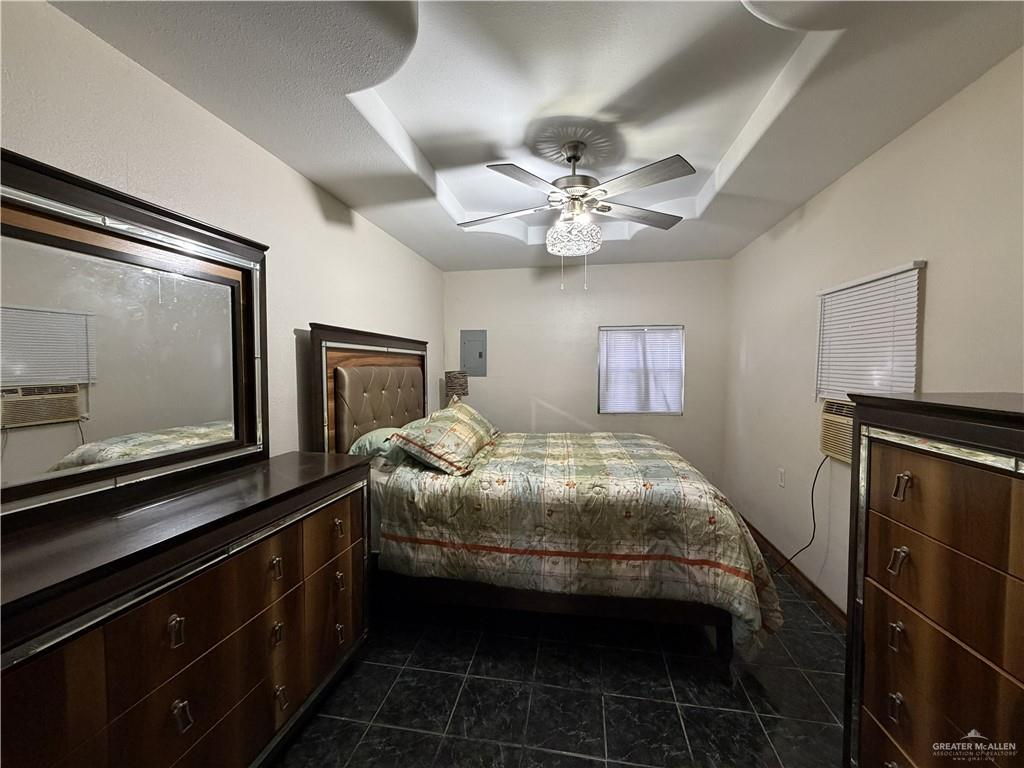 9014 North Abram Road Mission, TX 78574 - Photo 12 of 14 a bedroom with a bed and a tv