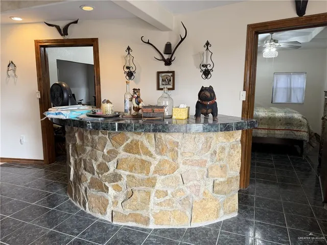 a bathroom with a granite countertop sink a mirror and vanity