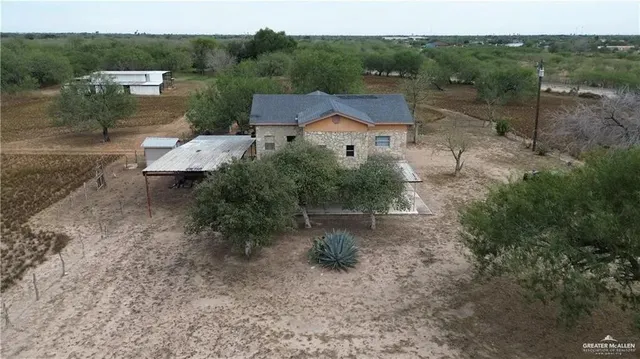 an aerial view of a house with backyard