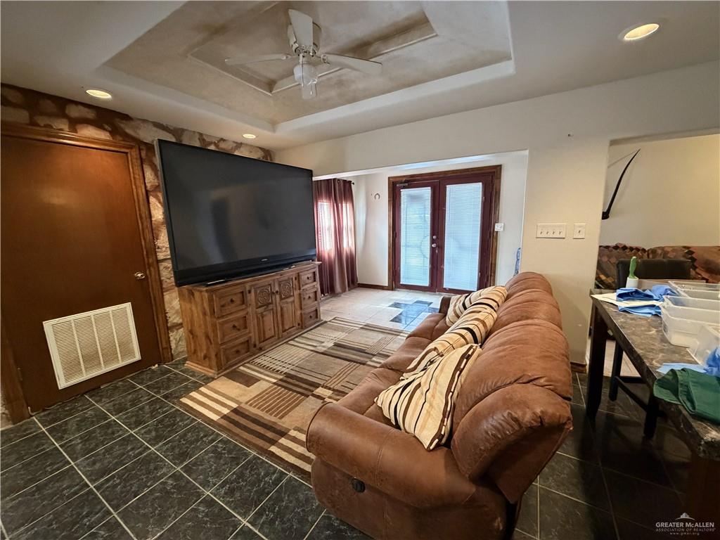 9014 North Abram Road Mission, TX 78574 - Photo 6 of 14 a living room with a couch and a flat screen tv