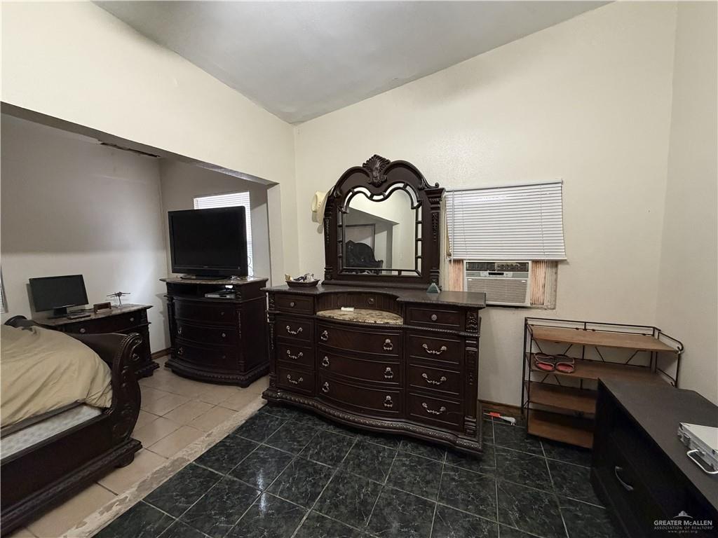 9014 North Abram Road Mission, TX 78574 - Photo 9 of 14 a bedroom with a bed and a television