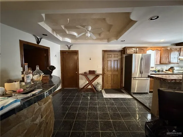 a kitchen with granite countertop a refrigerator and a sink