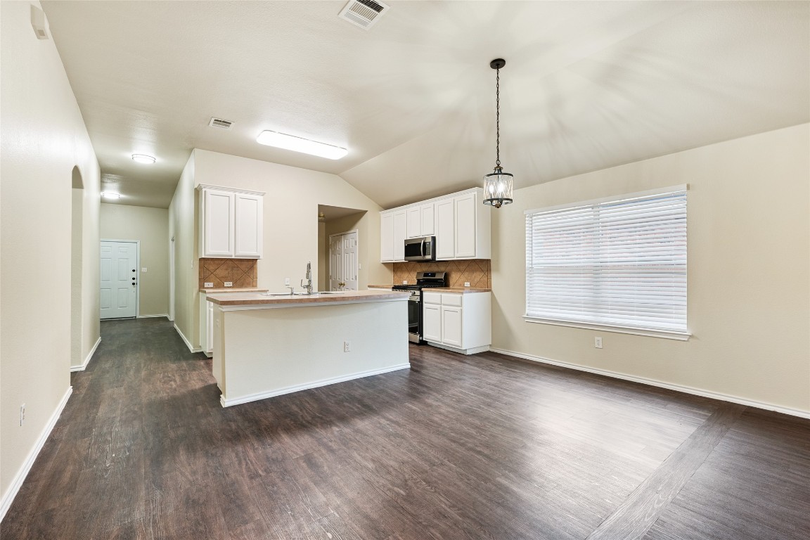 4009 Veiled Falls Drive Pflugerville, TX 78660 - Photo 12 of 26 a view of a kitchen with wooden floor
