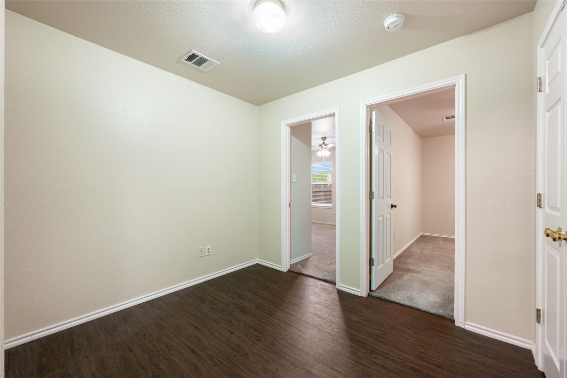 4009 Veiled Falls Drive Pflugerville, TX 78660 - Photo 20 of 26 an empty room with wooden floor & windows