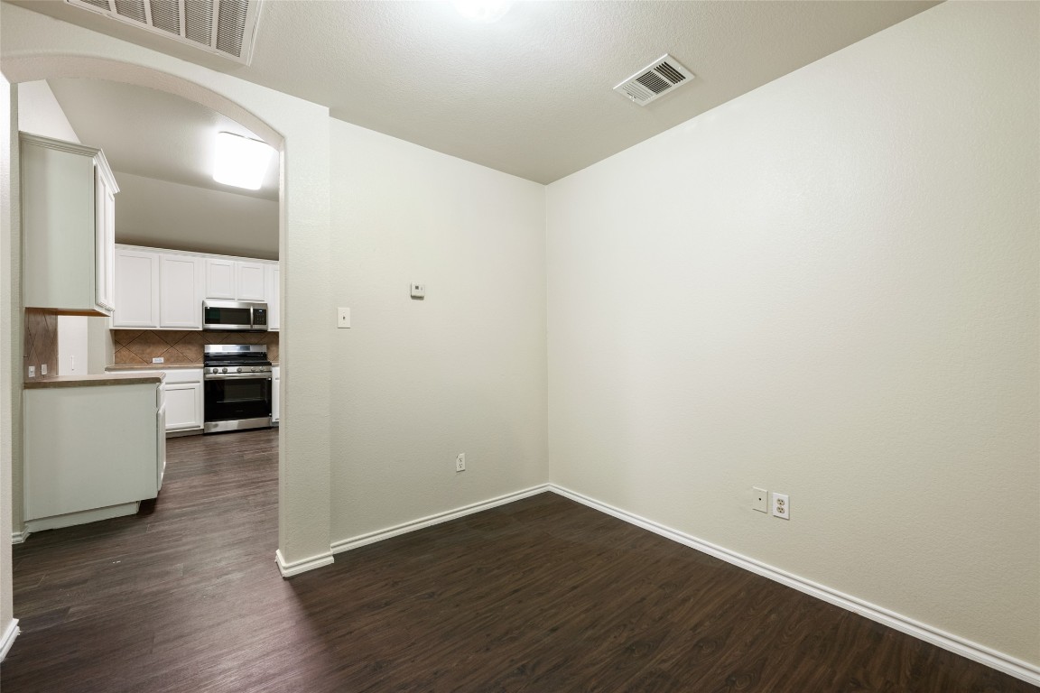 4009 Veiled Falls Drive Pflugerville, TX 78660 - Photo 21 of 26 a view of a kitchen with wooden floor and electronic appliances