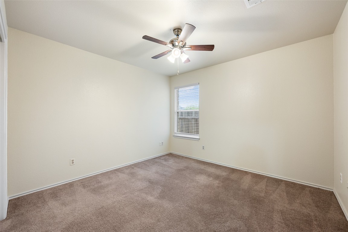 4009 Veiled Falls Drive Pflugerville, TX 78660 - Photo 22 of 26 an empty room with a window and a fan