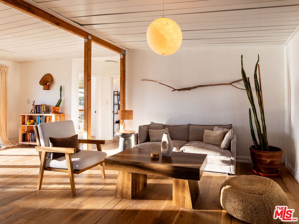 2724 Stonehill Avenue Joshua Tree, CA 92252 - Photo 34 of 65 a living room with furniture a rug and a large window