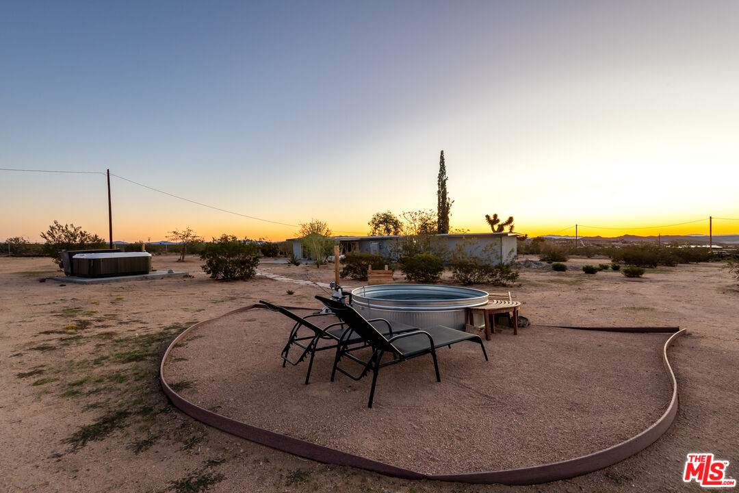 2724 Stonehill Avenue Joshua Tree, CA 92252 - Photo 37 of 65 a view of a swimming pool with lounge chair