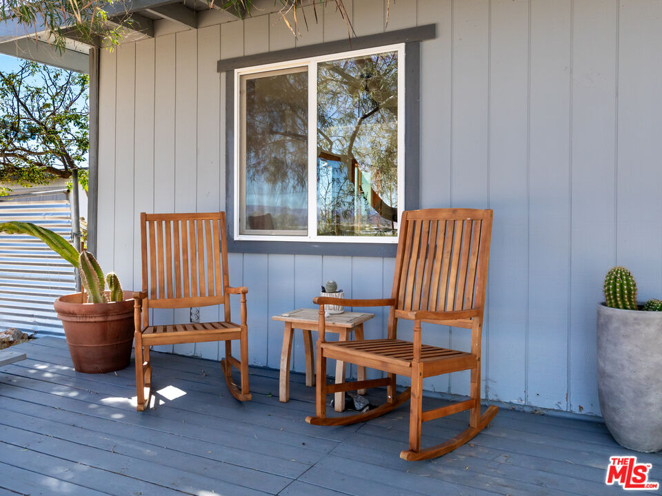 2724 Stonehill Avenue Joshua Tree, CA 92252 - Photo 43 of 65 a living room filled with furniture and a window