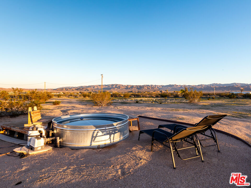 2724 Stonehill Avenue Joshua Tree, CA 92252 - Photo 47 of 65 a view of a lake with couches and city view