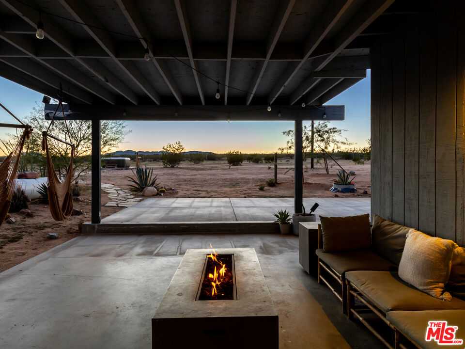 2724 Stonehill Avenue Joshua Tree, CA 92252 - Photo 53 of 65 a living room with furniture and a large window
