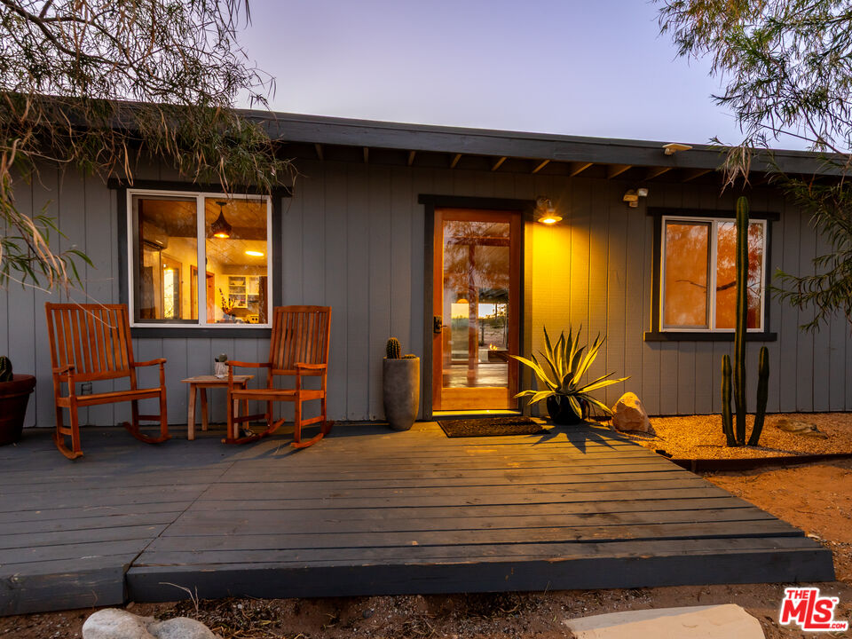 2724 Stonehill Avenue Joshua Tree, CA 92252 - Photo 57 of 65 a bedroom with a bed and wooden floor