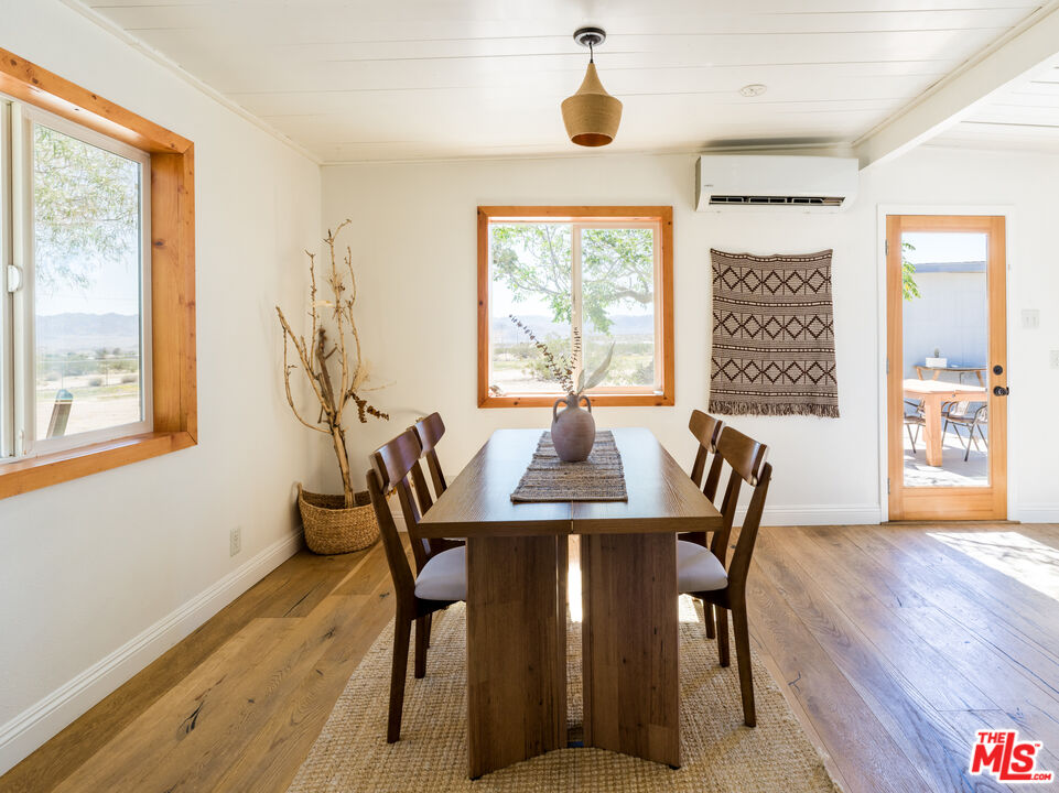 2724 Stonehill Avenue Joshua Tree, CA 92252 - Photo 6 of 65 a view of a dining room with furniture and wooden floor