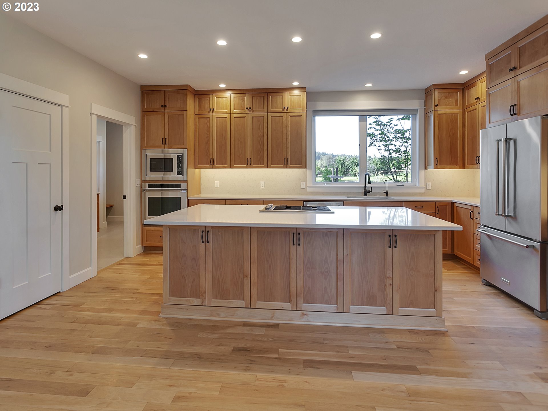 16939 Southwest Wilsonville Road Wilsonville, OR 97070 - Photo 11 of 43 a large kitchen with granite countertop a large counter top stainless steel appliances and windows