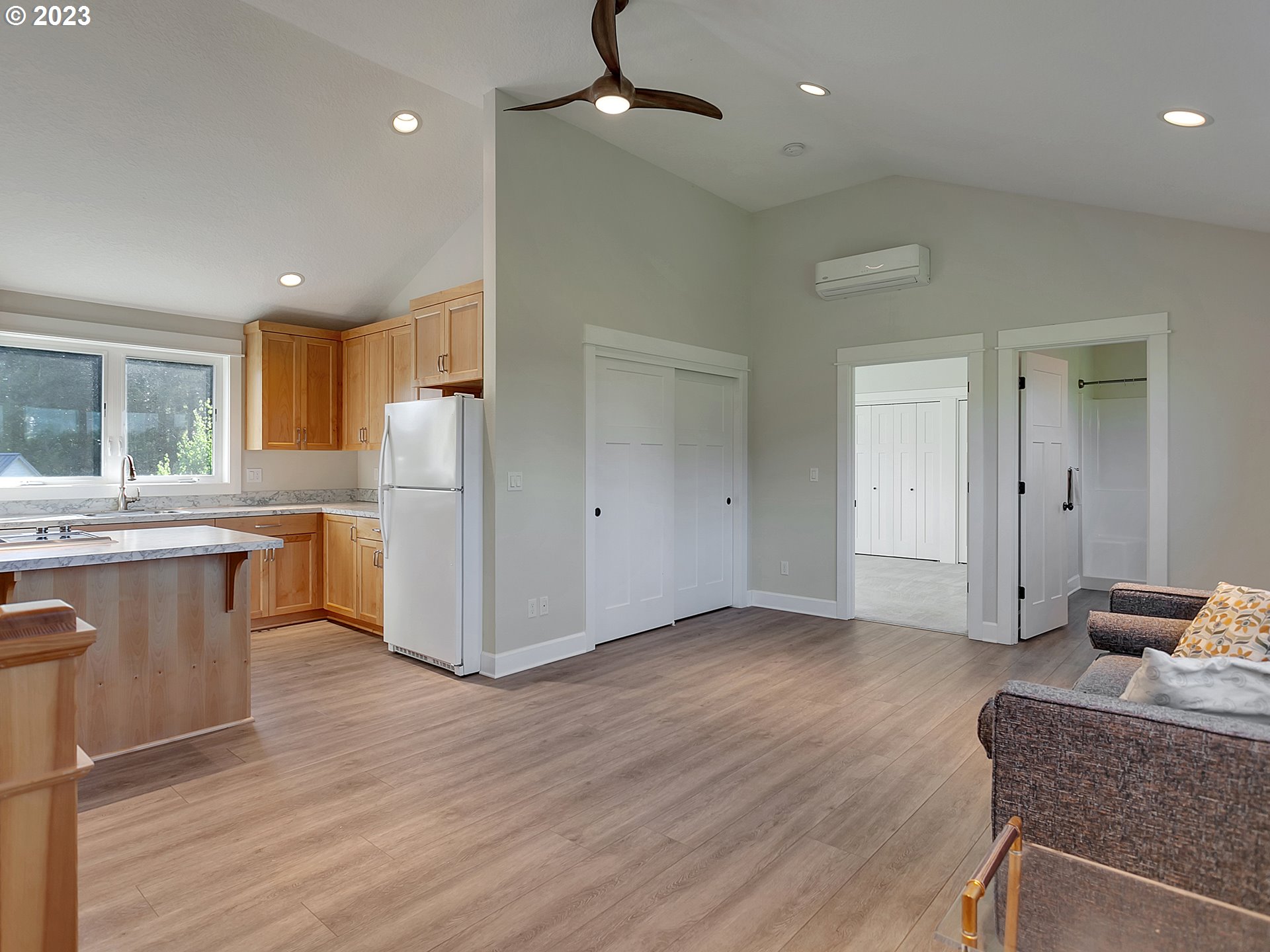 16939 Southwest Wilsonville Road Wilsonville, OR 97070 - Photo 33 of 43 a kitchen with kitchen island granite countertop wooden floors and white cabinets