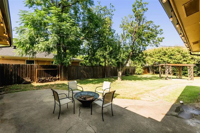 a view of a patio with table and chairs and potted plants