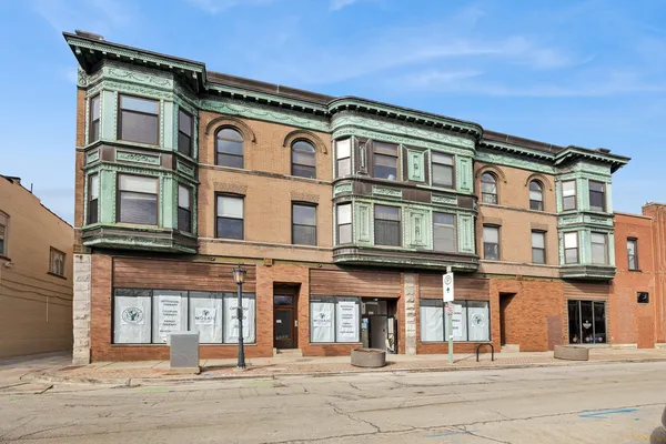 a front view of a residential apartment building with a yard