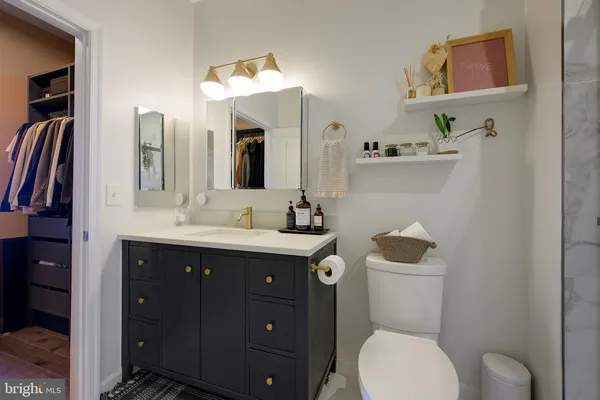 a bathroom with a toilet sink and mirror