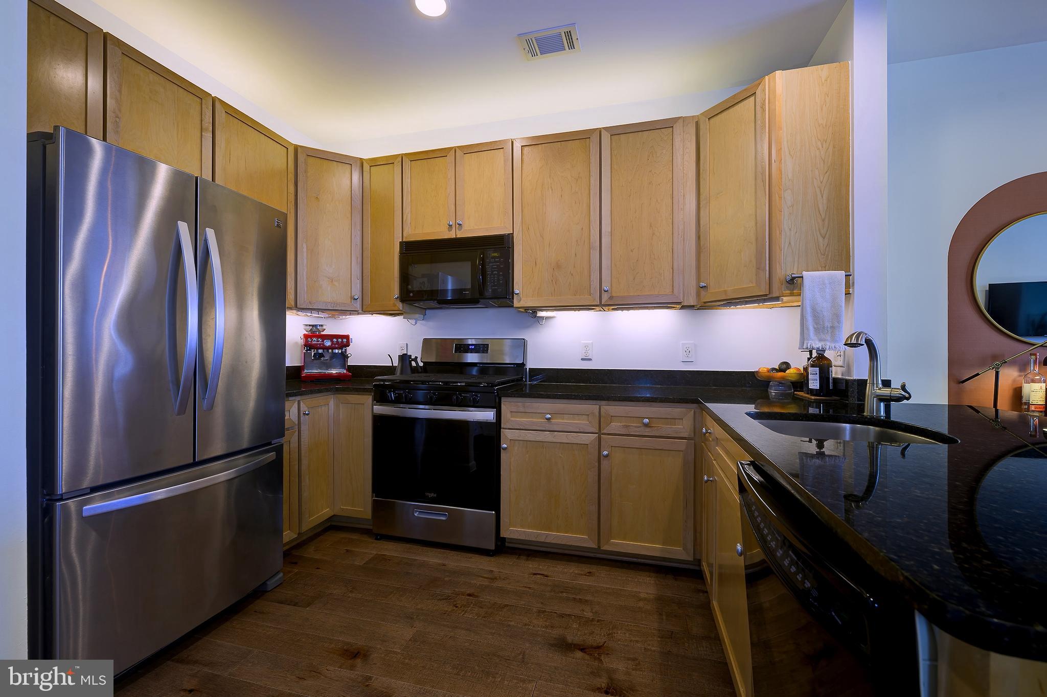 8045 Newell Street, Unit 514 Silver Spring, MD 20910 - Photo 3 of 19 Enter into the renovated kitchen