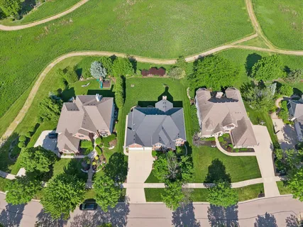 an aerial view of a house with a garden and lake view