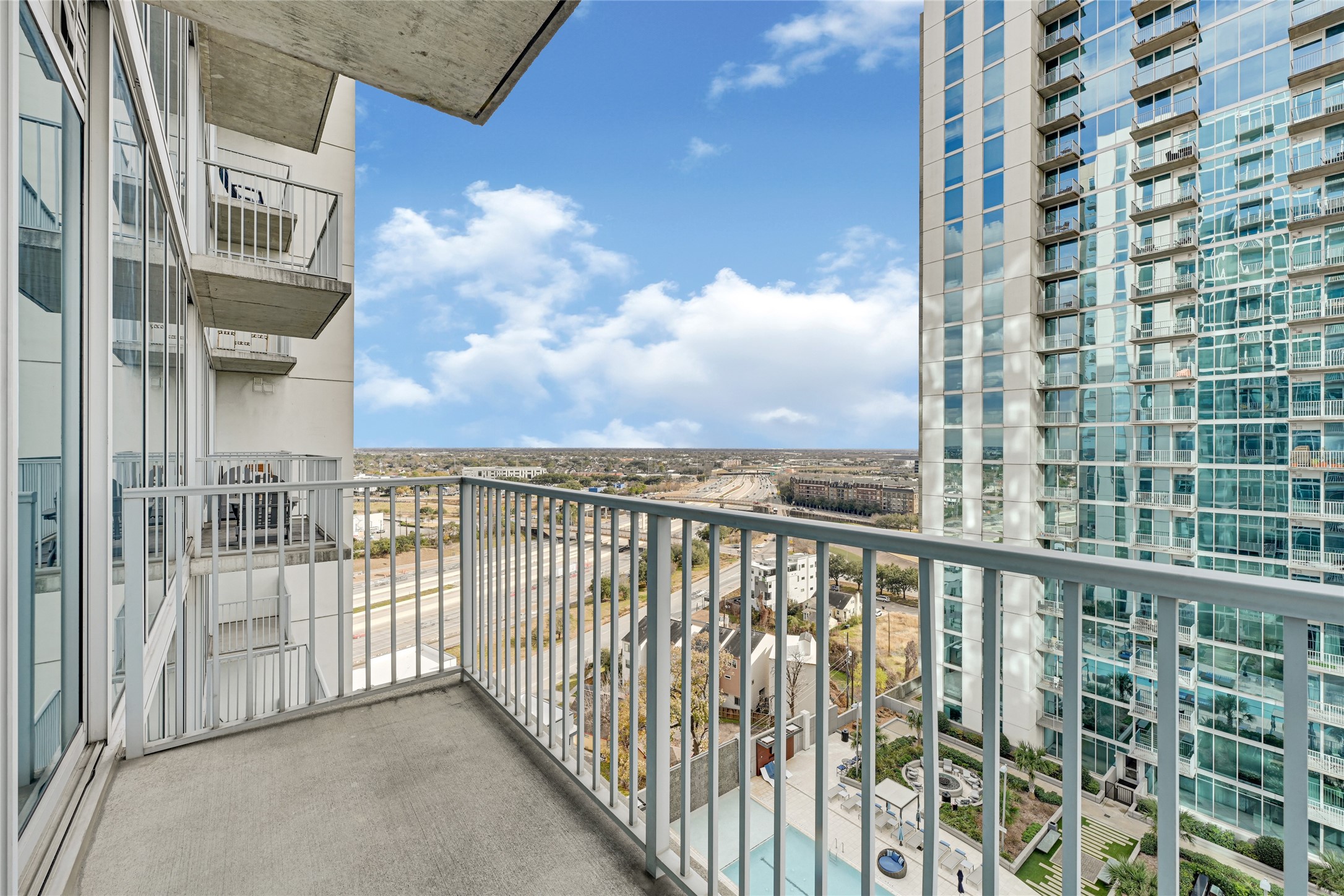 5925 Almeda Road, Unit 11508 Houston, TX 77004 - Photo 18 of 44 a view of a balcony with a floor to ceiling window and brick walls