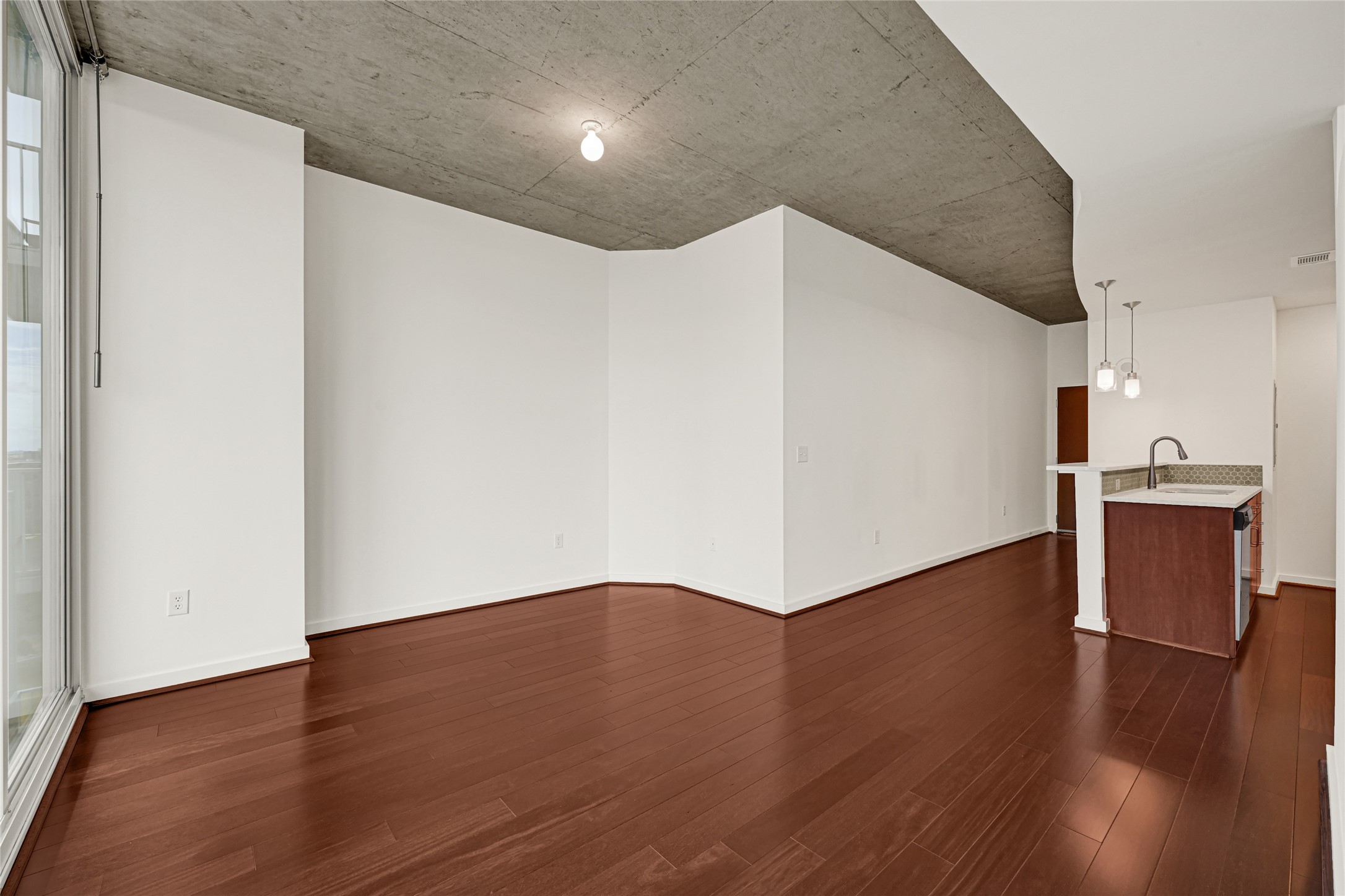 5925 Almeda Road, Unit 11508 Houston, TX 77004 - Photo 4 of 44 a view of an empty room with wooden floor
