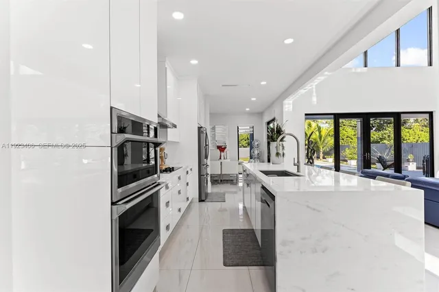 a view of a house with swimming pool and sitting area