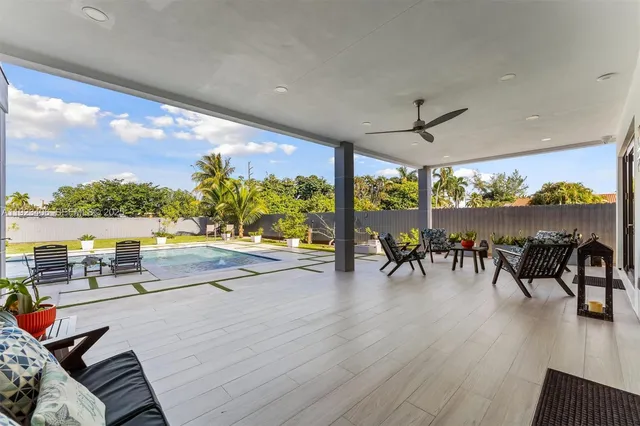 a view of a house with swimming pool and sitting area