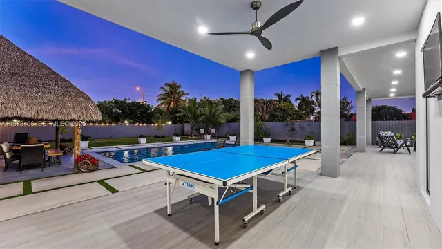 a view of a balcony with chairs and wooden floor