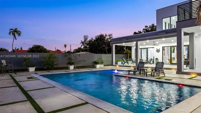 an aerial view of a house with a garden and lake view