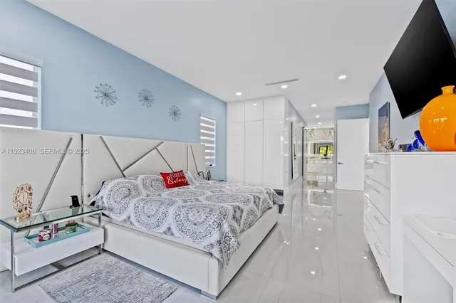 a view of a white house with a big yard and large trees