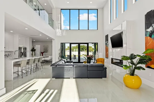 a kitchen with stainless steel appliances kitchen island granite countertop a refrigerator and a sink