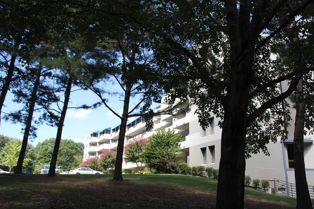 a view of white house with a tree in the background