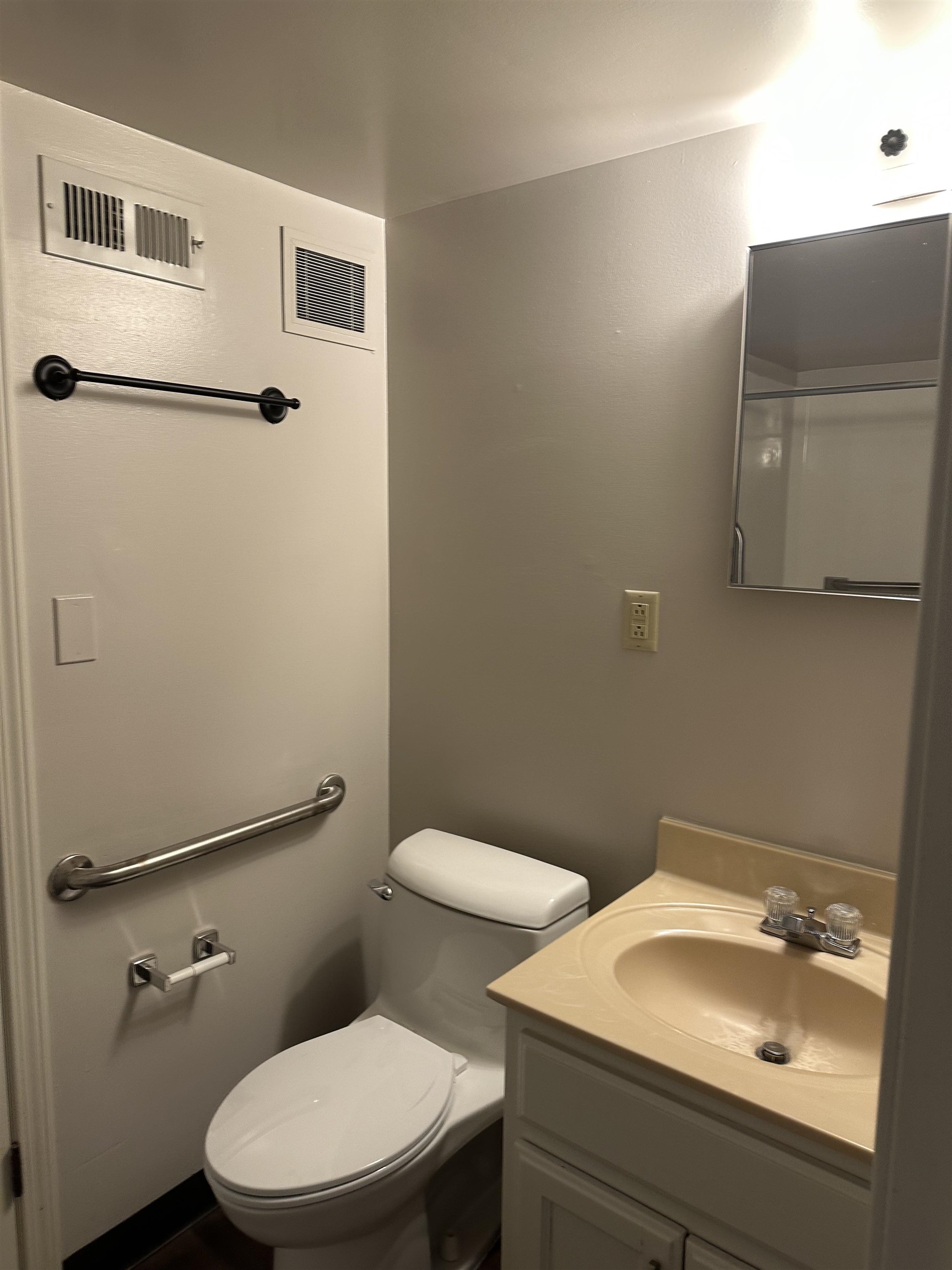 3589 Covington Pike, Unit 214 Memphis, TN 38128 - Photo 9 of 12 a white toilet sitting next to a bathroom sink