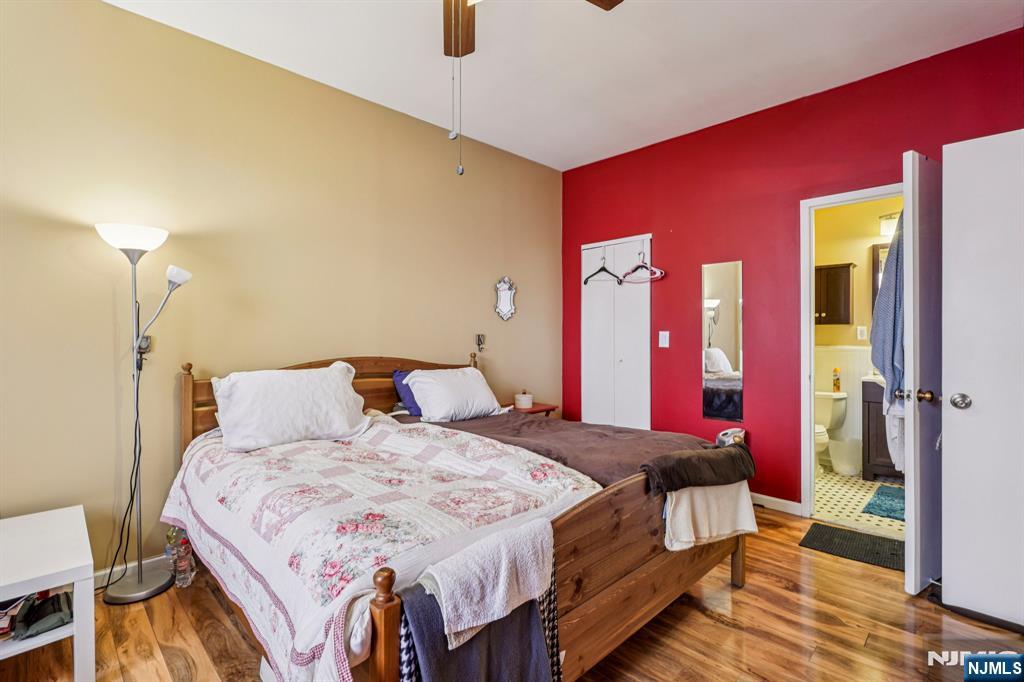 111 Mulberry Street, Unit 2V Newark, NJ 07102 - Photo 15 of 27 a bedroom with a bed and a mirror