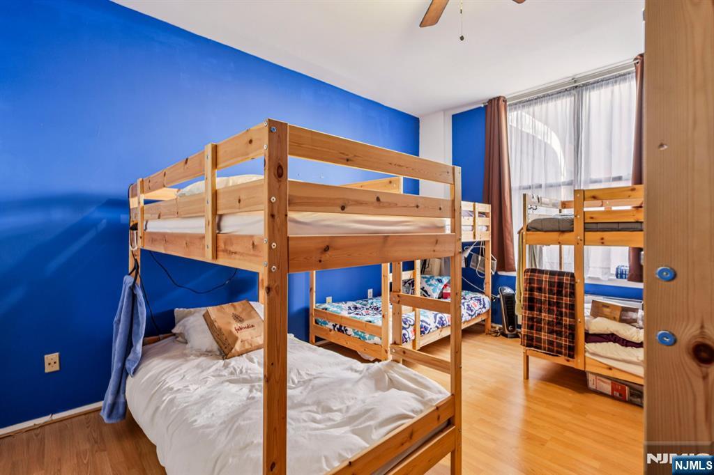 111 Mulberry Street, Unit 2V Newark, NJ 07102 - Photo 16 of 27 a bedroom with a bed and wooden floor