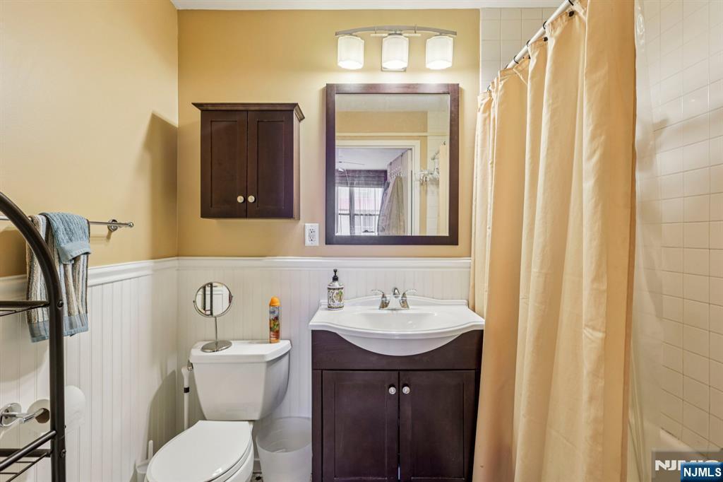 111 Mulberry Street, Unit 2V Newark, NJ 07102 - Photo 19 of 27 a bathroom with a toilet sink and mirror