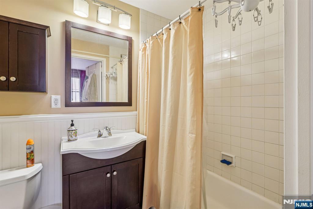 111 Mulberry Street, Unit 2V Newark, NJ 07102 - Photo 20 of 27 a bathroom with a sink a toilet and shower curtain