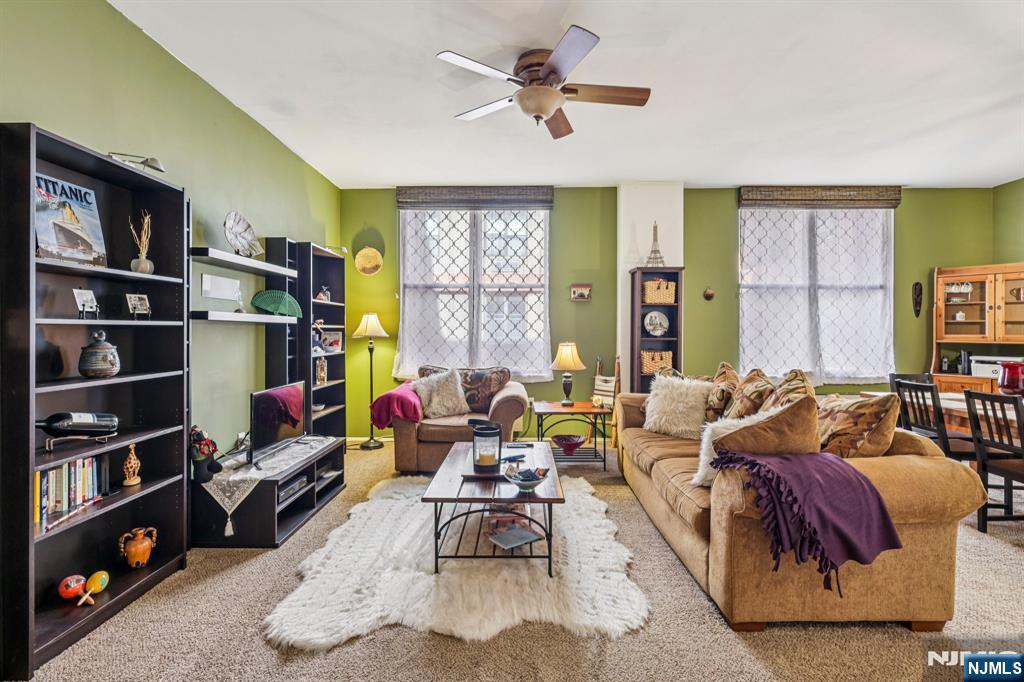 111 Mulberry Street, Unit 2V Newark, NJ 07102 - Photo 3 of 27 a living room with furniture a rug and a window