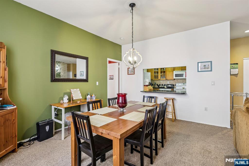 111 Mulberry Street, Unit 2V Newark, NJ 07102 - Photo 9 of 27 a view of a dining room with furniture and a chandelier
