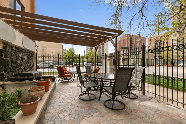 a view of a patio with a table chairs and a potted plant