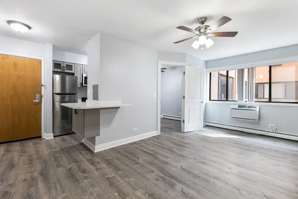 a view of a kitchen with wooden floor and electronic appliances