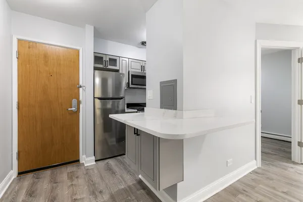 a kitchen with stainless steel appliances a refrigerator and microwave