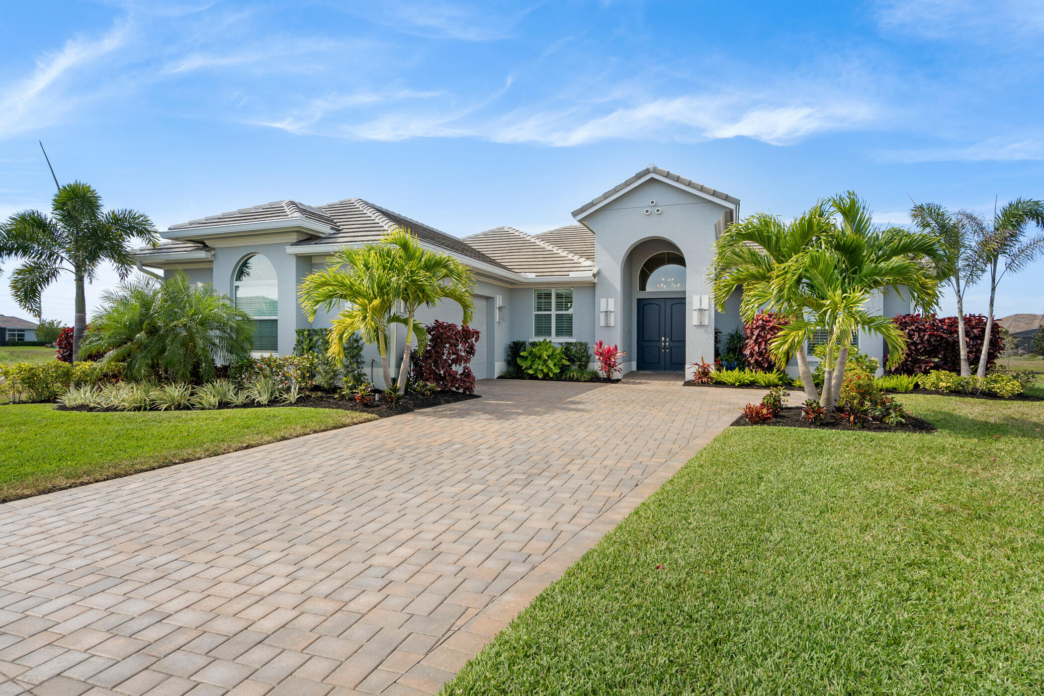 a view of a house with a yard and large tree