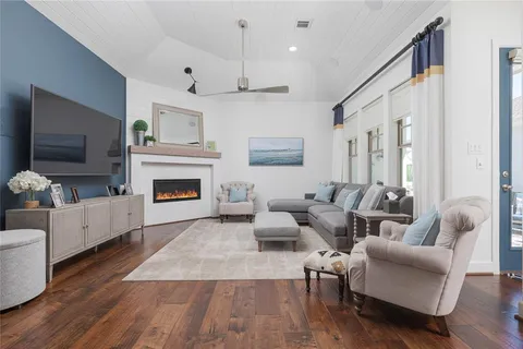 a living room with furniture fireplace and flat screen tv