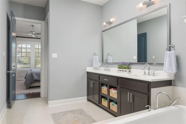 a en suite bathroom with a double vanity sink a mirror and a shower