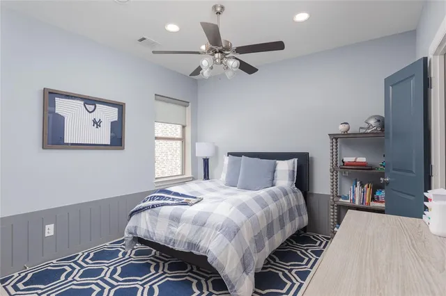 a bedroom with a bed and a tv