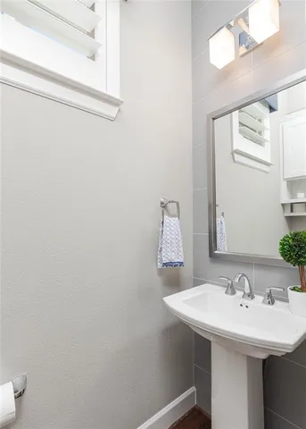 a bathroom with a sink a mirror and a toilet