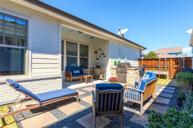 a view of a patio with a table and chairs